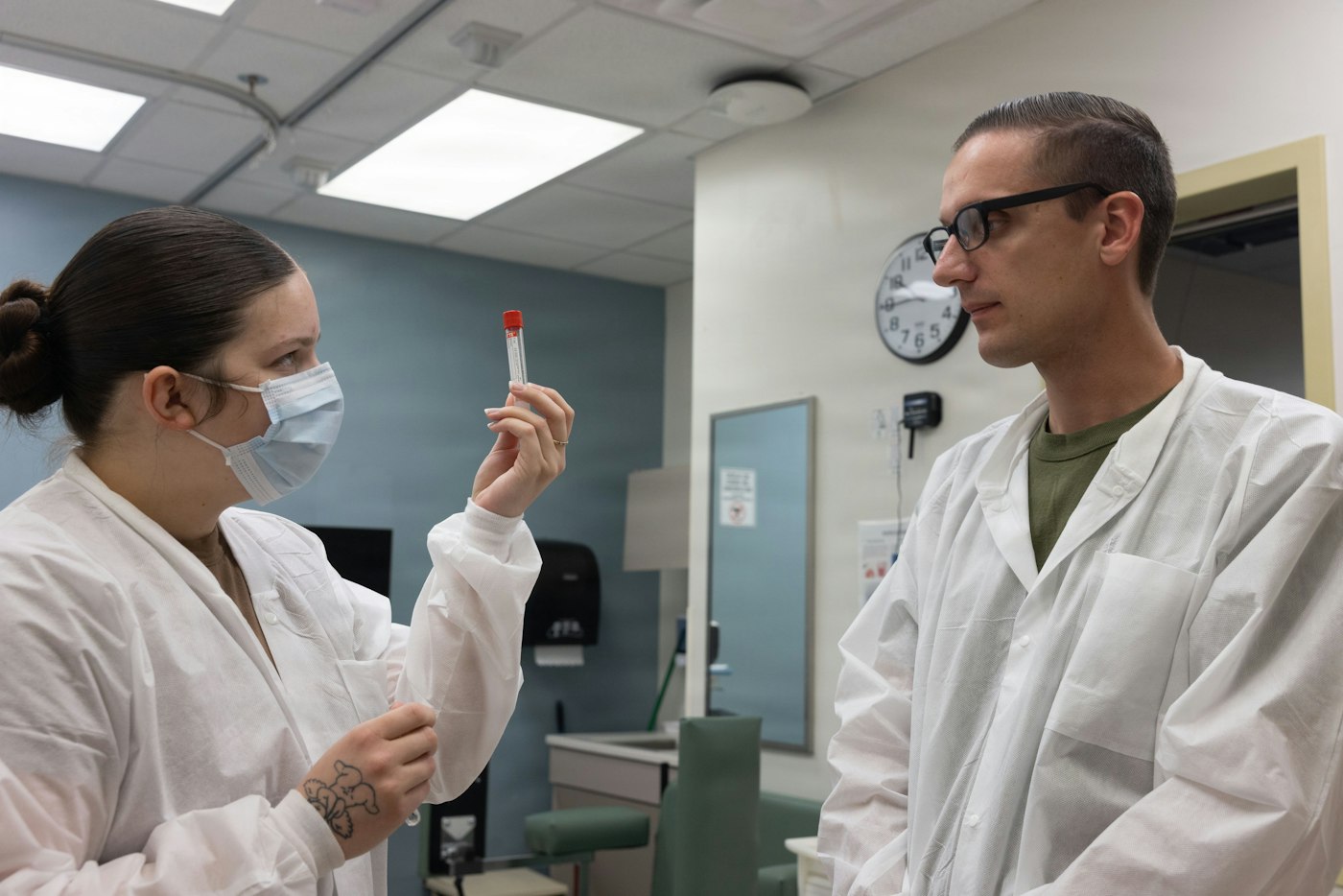 Two scientists discussing a sample in the laboratory